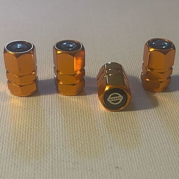 Nissan Logo Valve Stem caps in Gold set of 4 NWT - Picture 3 of 4